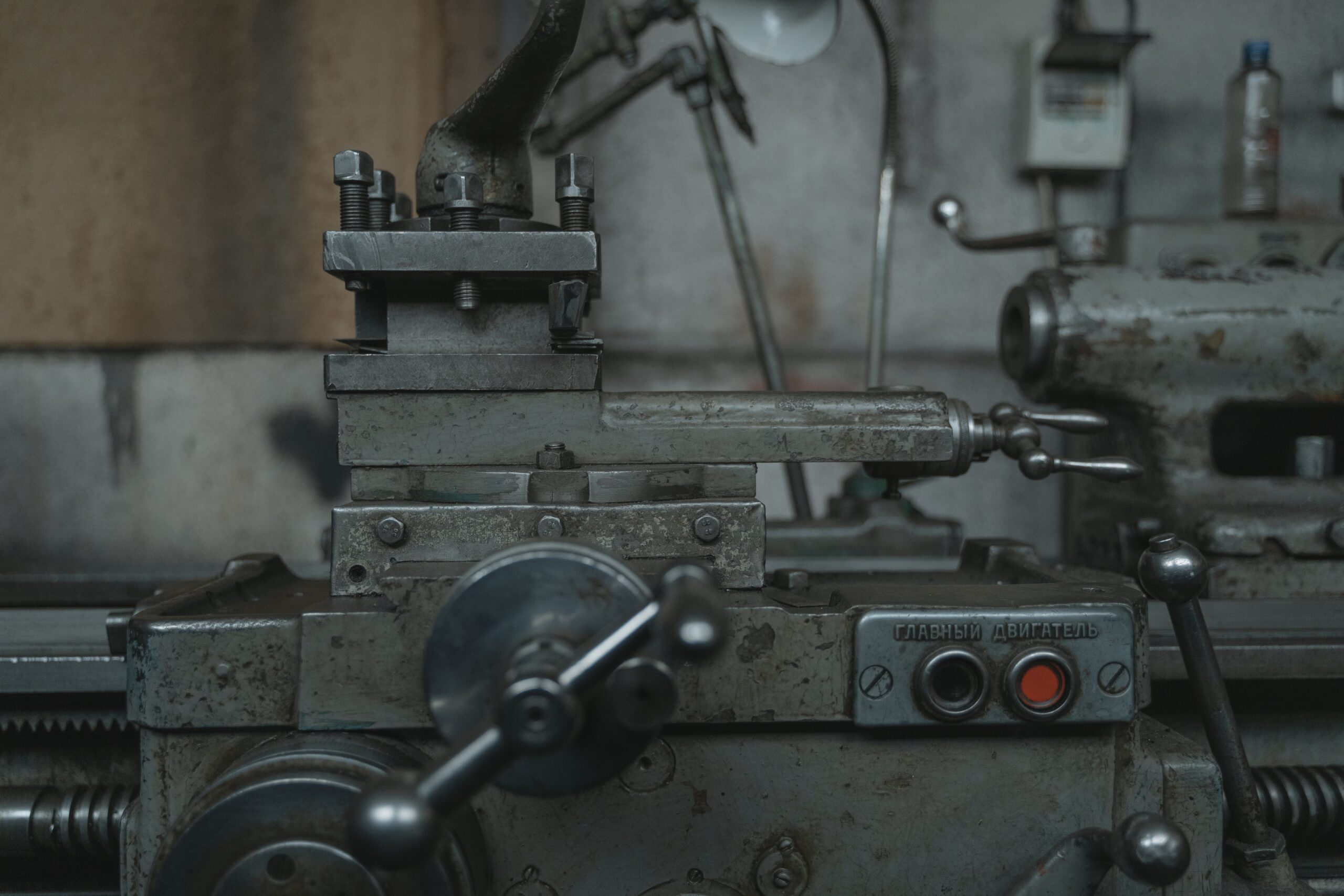 Close-up of an antique lathe showcasing tools and machinery in a vintage workshop.